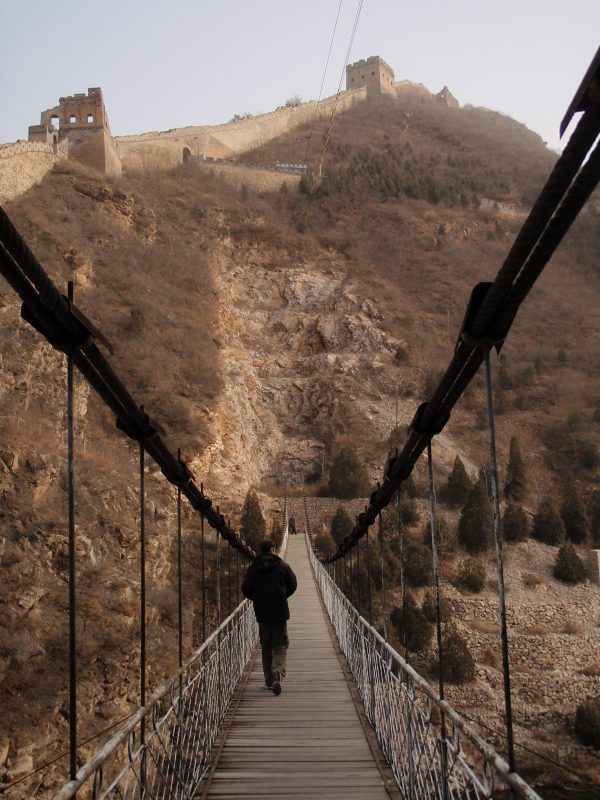 Walking the wild Great Wall of China from Jinshanling - walking across one of the rope bridges to the towers in late autumn weather