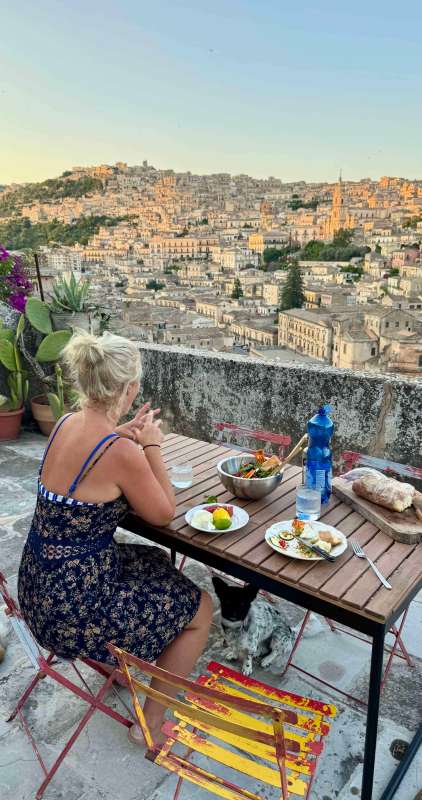 Views down towards central Modica from the balcony on Villa Rosa as the sun is setting from a scorching day